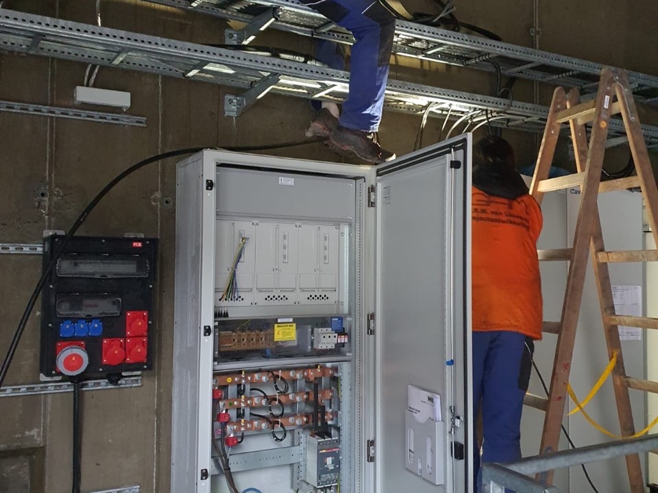 Elektrikár COME WORKS pri práci na rozvádzači na stavbe